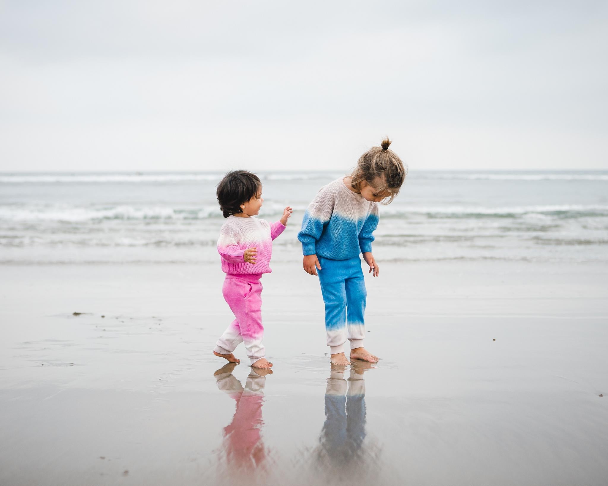 Kids pink dip dye sweater and matching sweatpants; kids blue dip dye sweater and matching sweatpants.