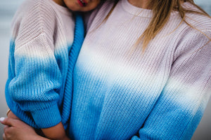 Close up of kids and women's matching blue dip dye sweater. 