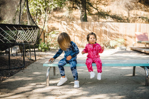 Kids indigo blue tie dye onesie and fuchsia pink tie dye onesie. 