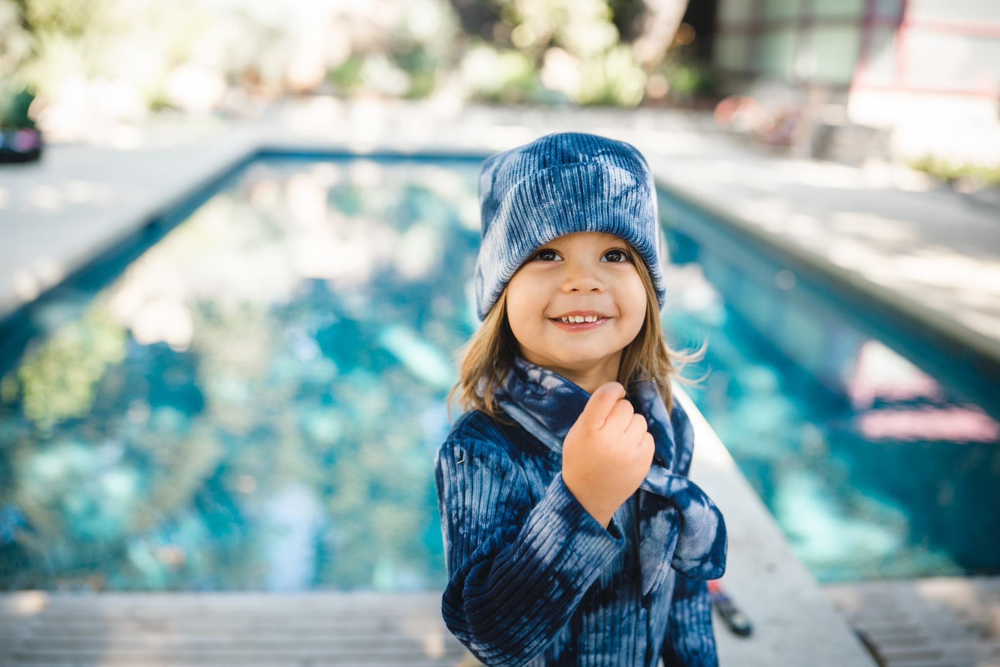 Close up of kids indigo blue tie dye beanie hat, matching scarf and onesie. 